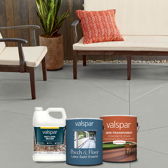 A gray cement patio, a modern outdoor couch and chair, plus Valspar protective sealer, porch, floor and concrete stain products.
