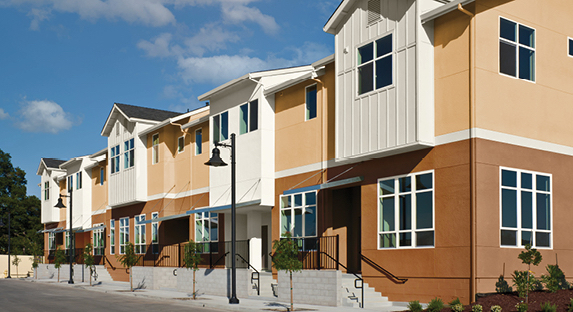 Row of attached homes with Gleaming Tan exterior first levels, Palomino Pony second floor exteriors and Polar White trim.