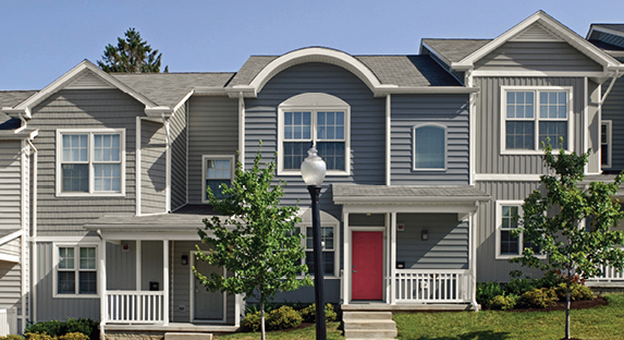Attached houses alternating with Night View and Aspen Gray exteriors and Gilded Linen trim. Center home has bright red door.